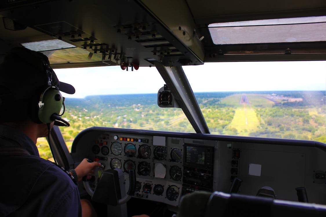 a pilot practicing system controls in a flight simulator     